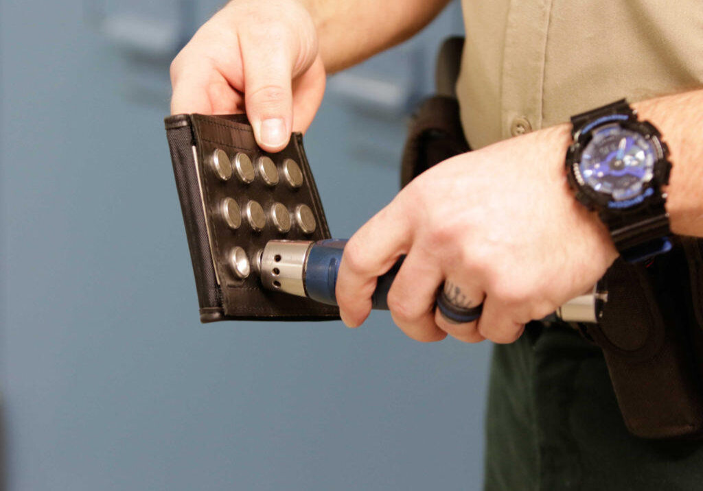 Correctional officer recording incident in incident wallet with The PIPE.